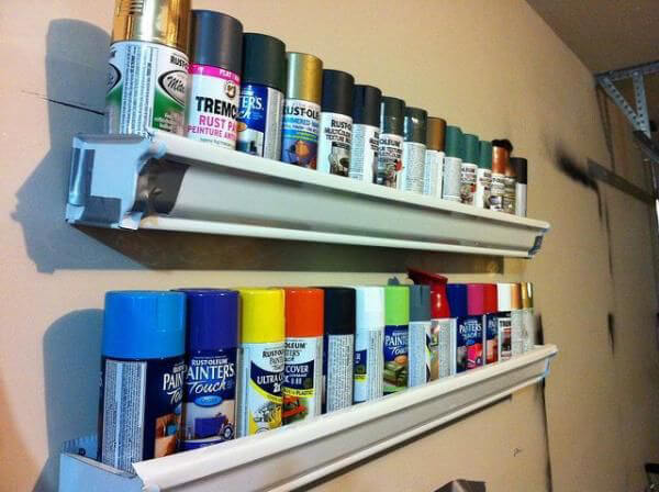 Store old spray paint cans and reuse that gutter at the same time!